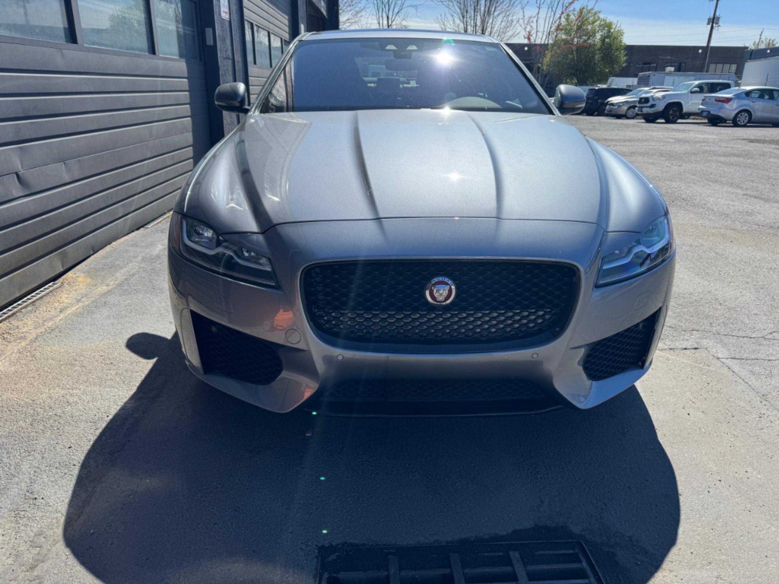 Before photo showing front-end collision damage on a customer vehicle awaiting repair