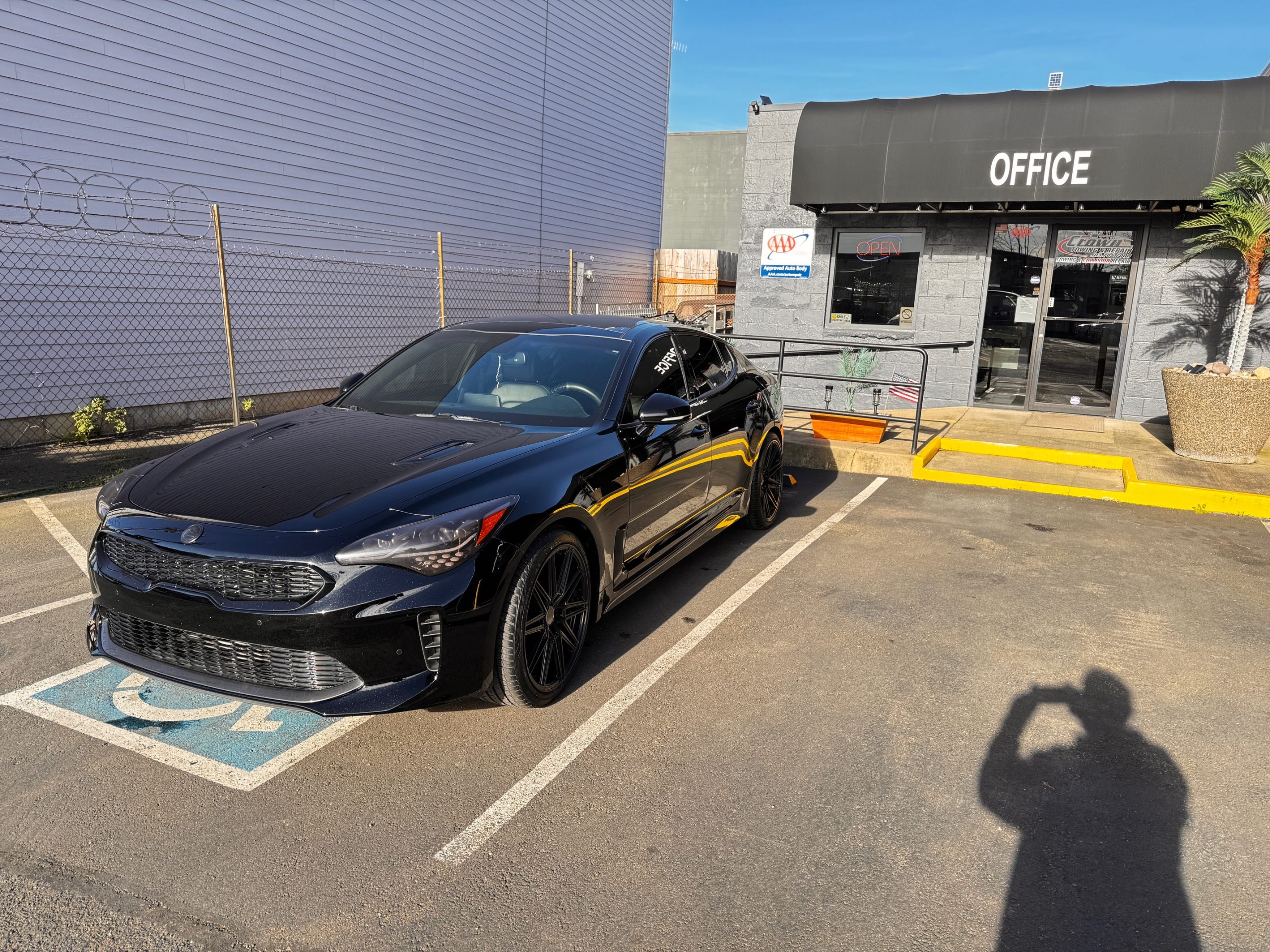 Tools, welding gear, and body-repair equipment organized inside Crown's Portland shop