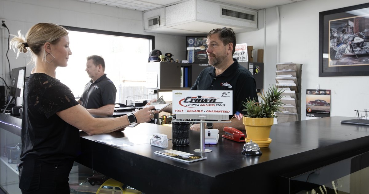 A customer speaking with a Crown staff member across the front desk at the Portland shop