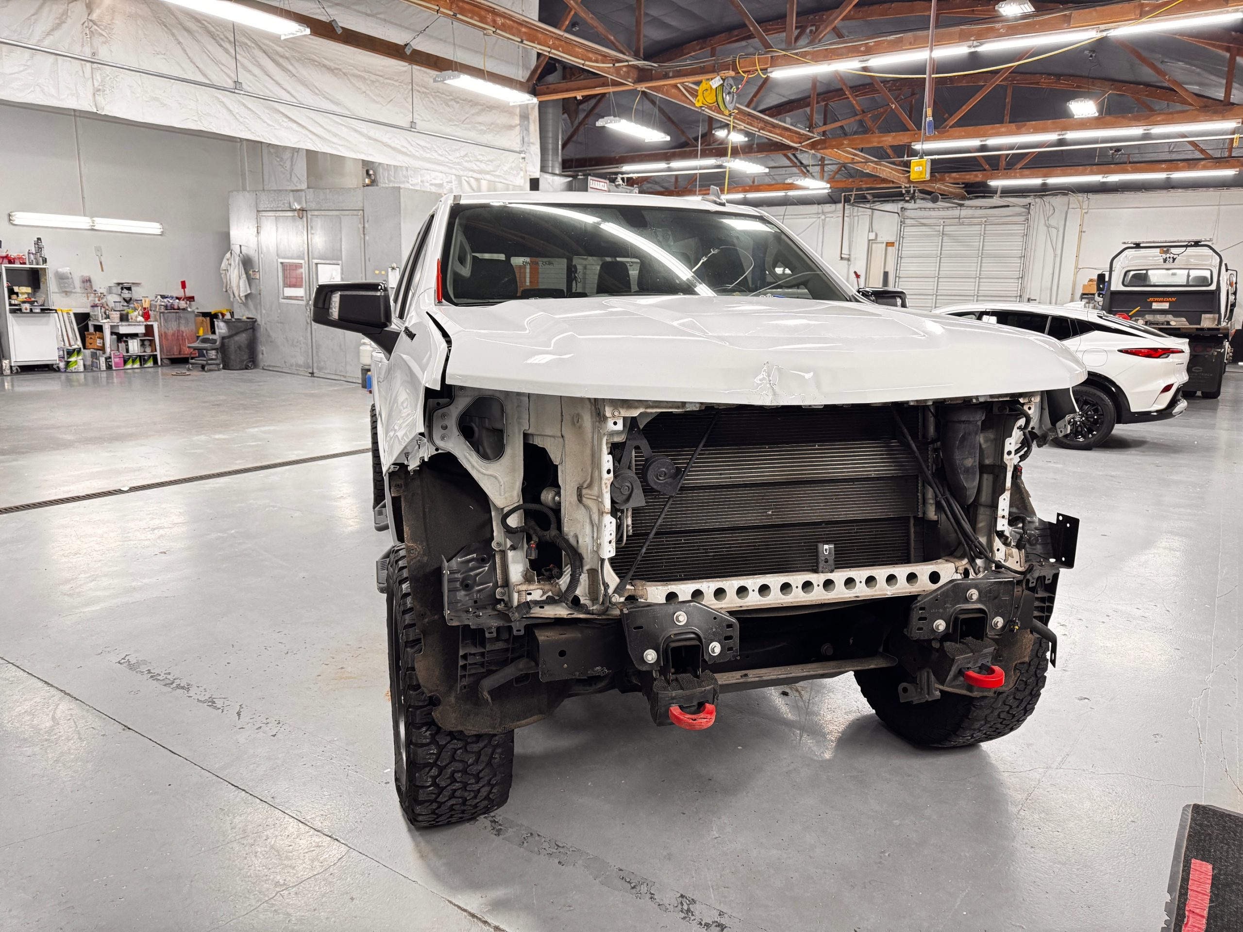 Crown shop bay with active collision repair work underway on a customer vehicle
