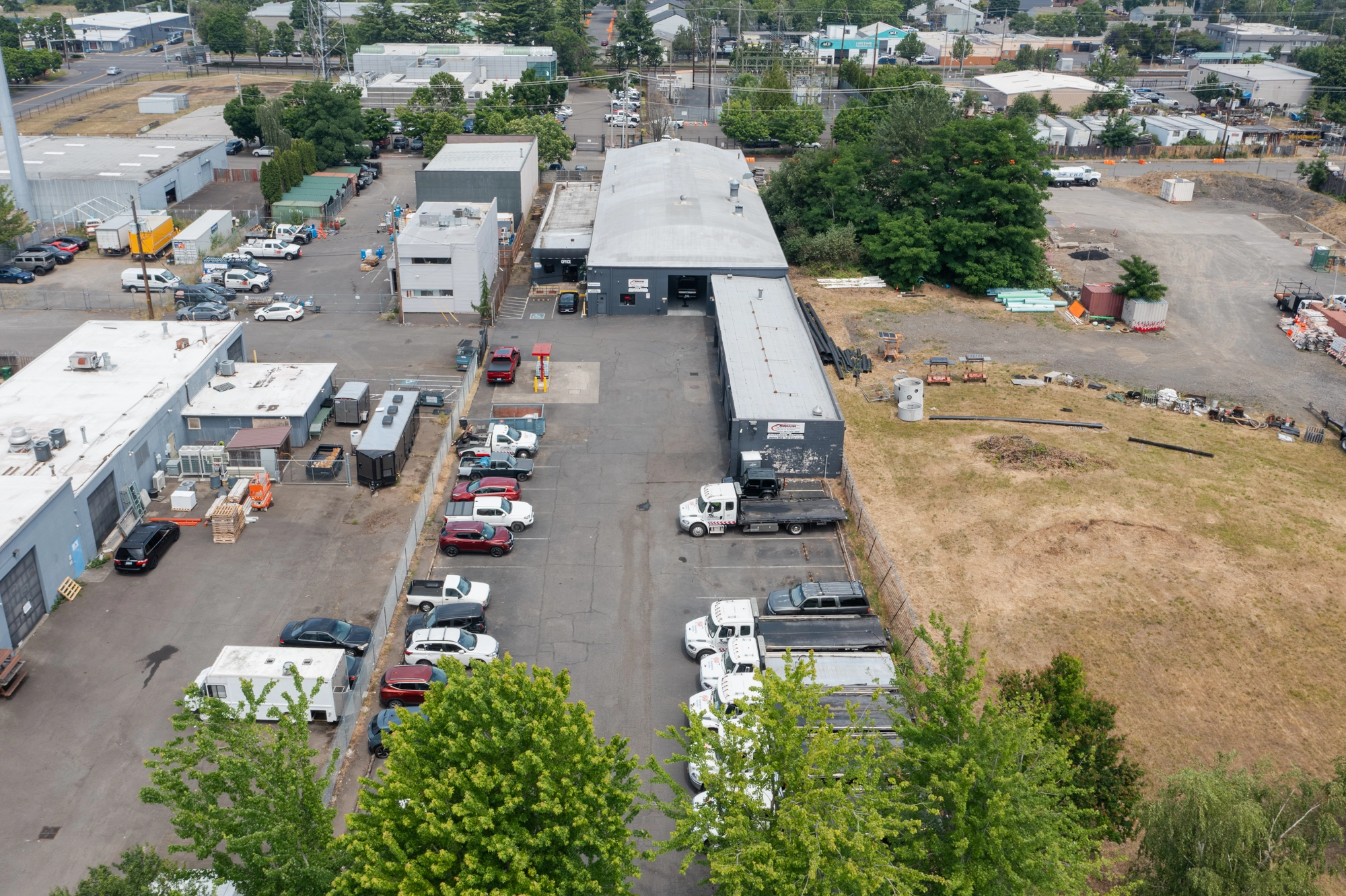 Crown Towing yard in Portland with flatbed tow trucks staged for roadside calls
