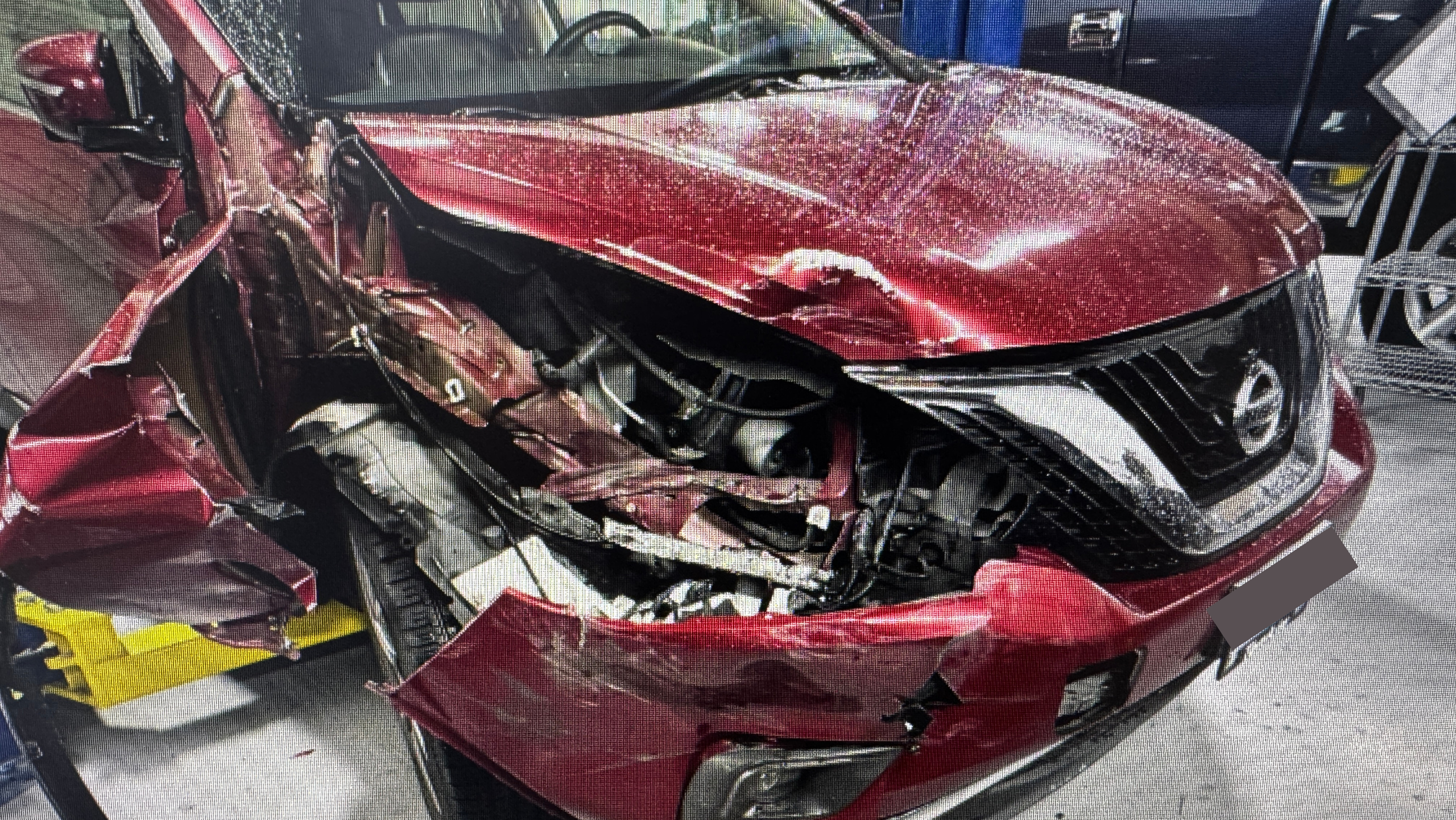 Crown crew members working on a vehicle inside the SE Portland collision shop