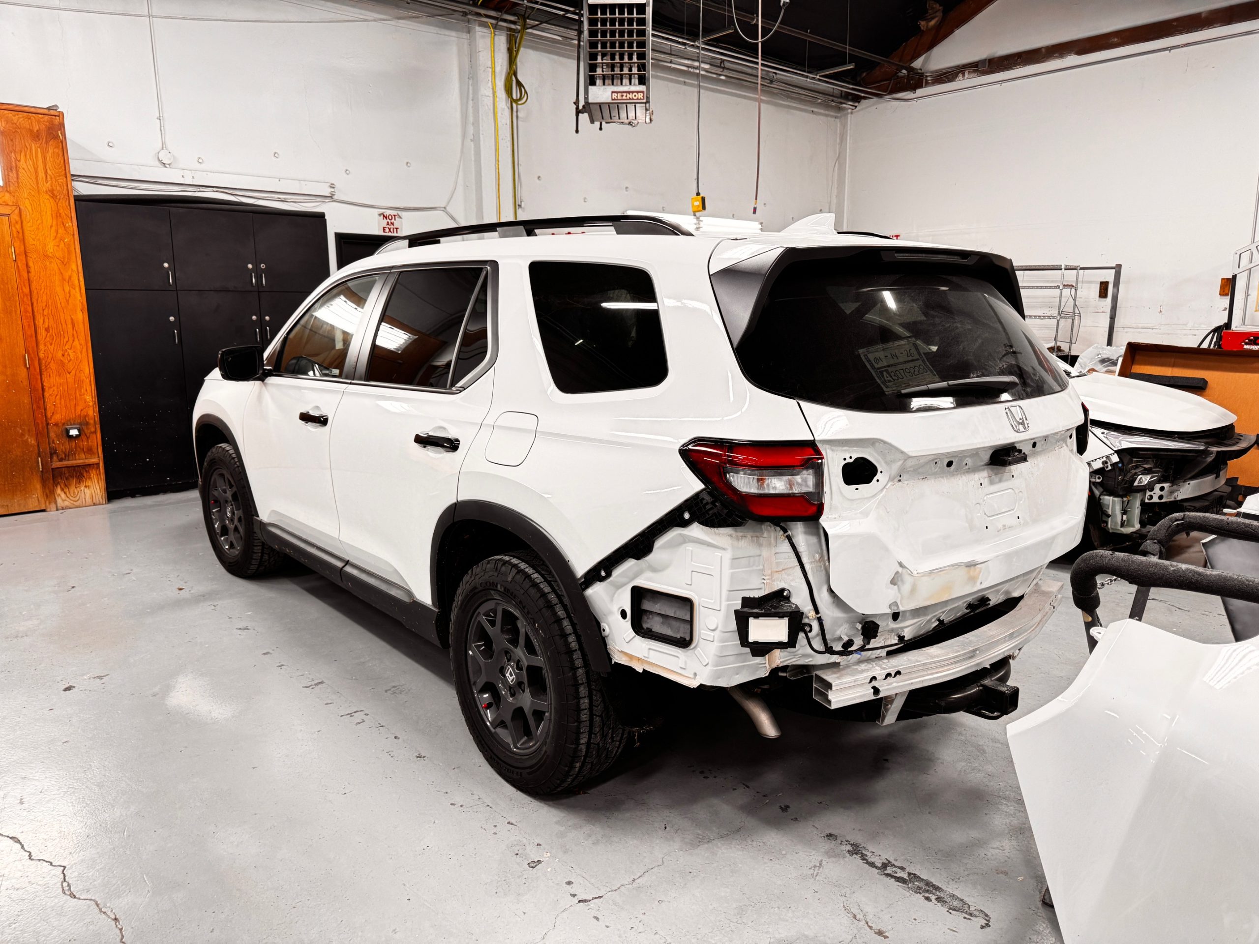 In-progress view of the collision repair process on a damaged customer vehicle