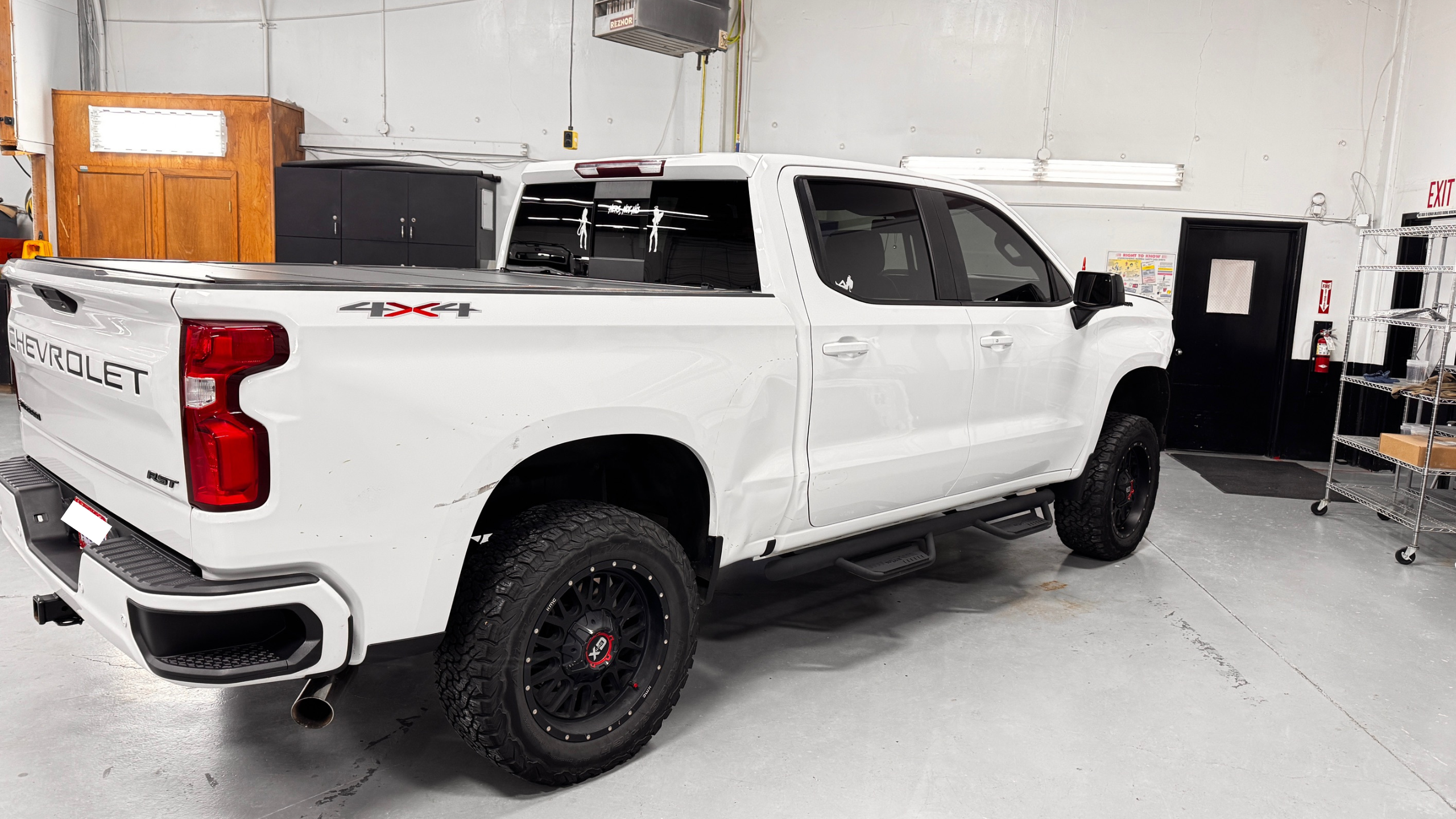 Crown auto body shop bay with a customer vehicle in for collision repair