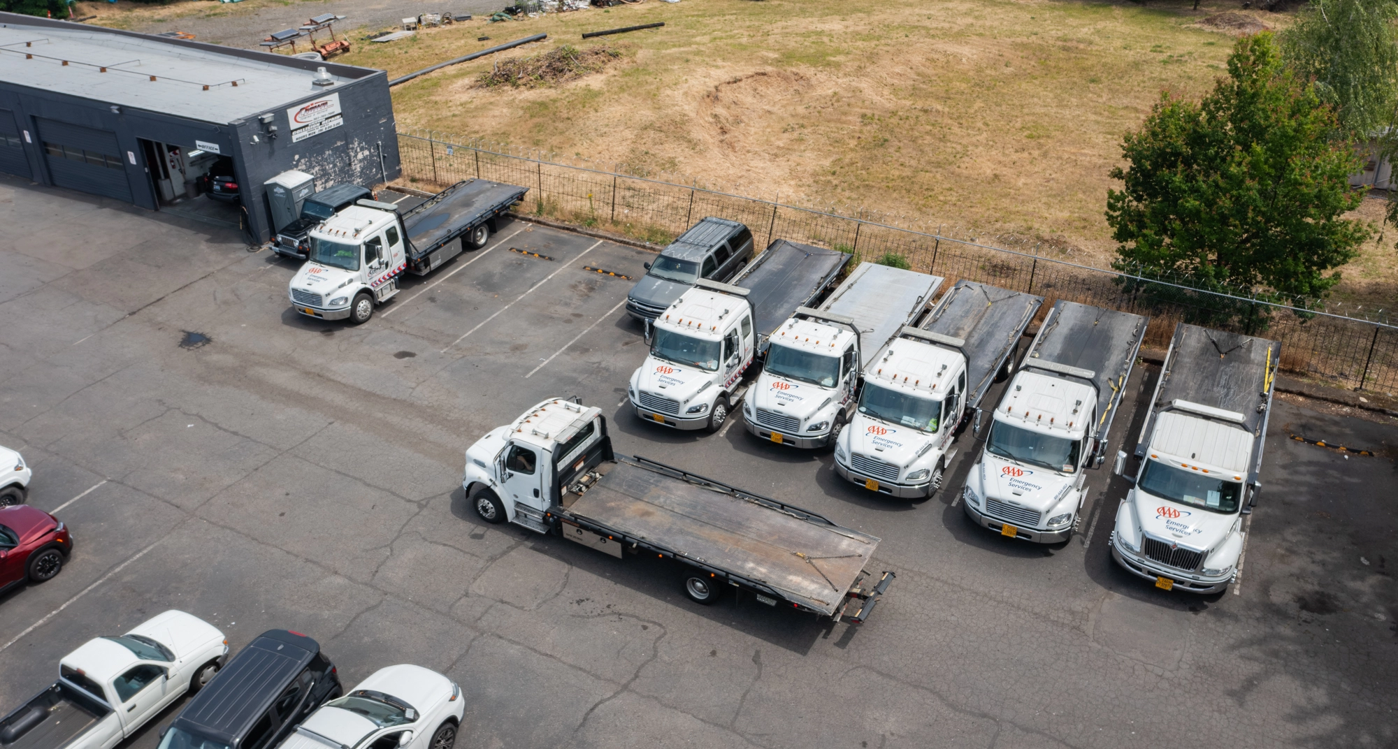 Crown Towing AAA-marked flatbed fleet parked at the Portland shop