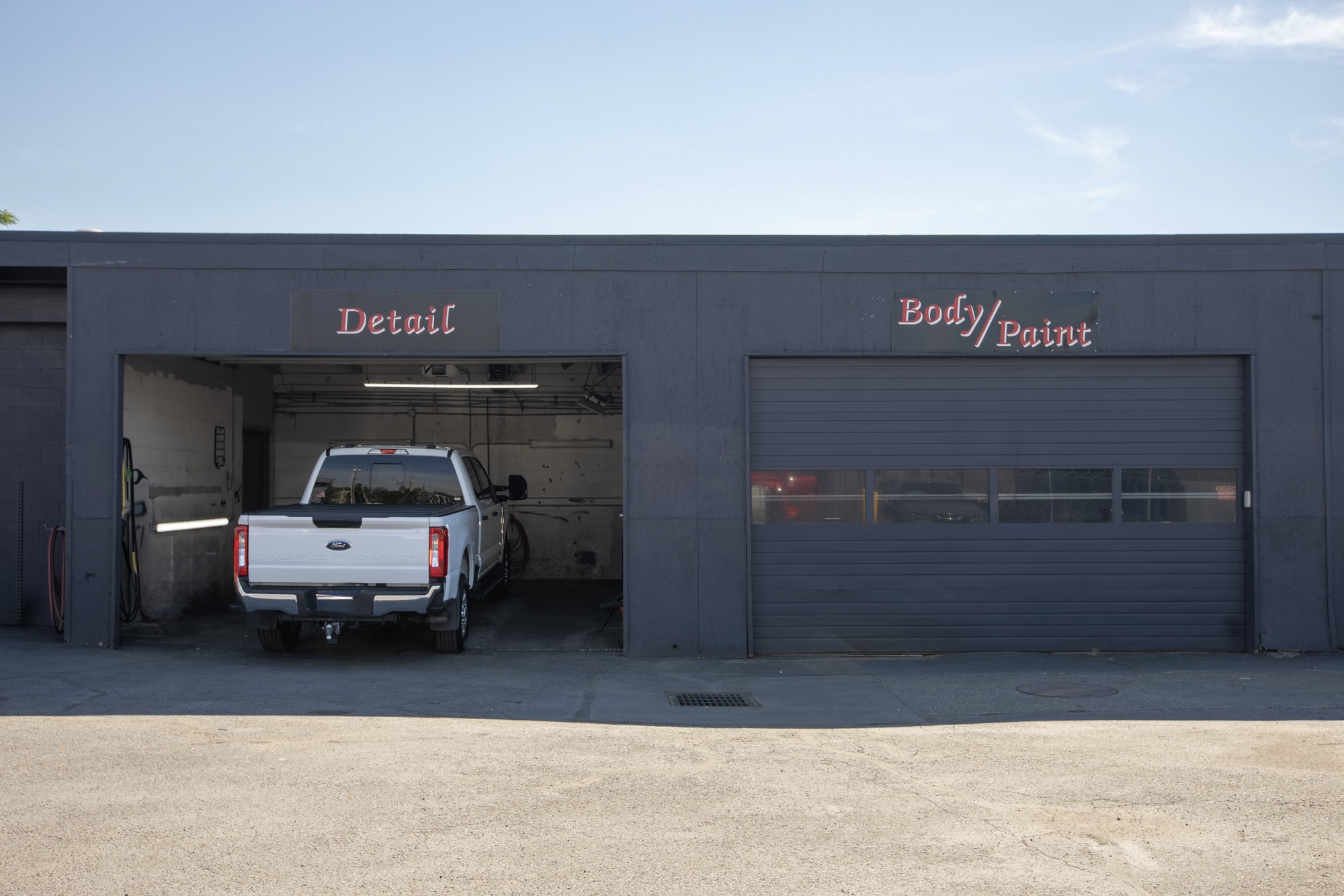 Detail and body-paint bays inside Crown's Portland collision repair facility