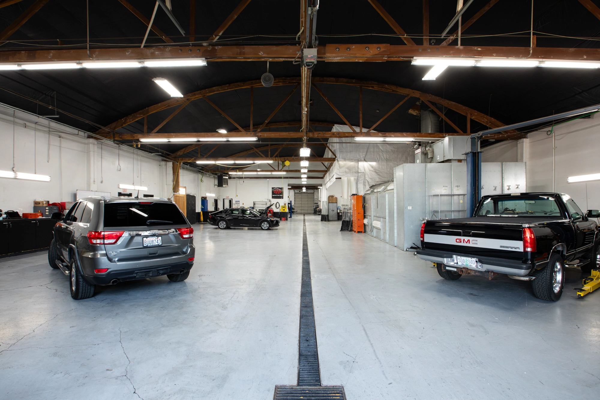 Crown Towing & Collision Repair shop floor with vehicles staged for repair in Portland